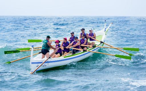 people paddling on sea